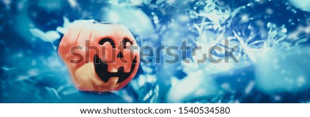 Halloween Pumpkin head demon In the blue snow field. Halloween Ghost Festival