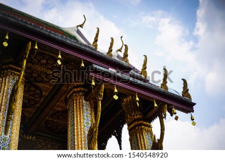 Detial of traditional Thai architecture. Temple detials of Wat Phra Kaew, Temple of the Emerald Buddha with blue sky Bangkok, Asia Thailand.