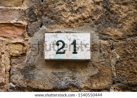 Close-Up Of Number 21 On stone wall