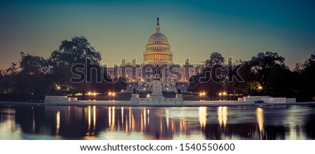 Panoramic image of the Capitol of the United States with the capitol reflecting pool in morning light. Royalty-Free Stock Photo #1540550600