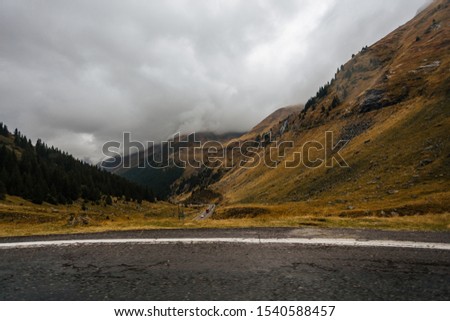 View of Transfagarash highway and valley in mountains of Romania. Tourist view mountain road. Autumn mountain landscape