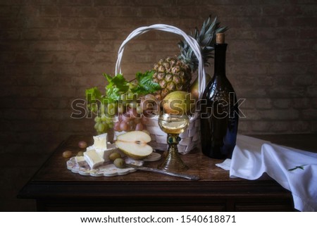 Still life with Brie cheese and white wine glass