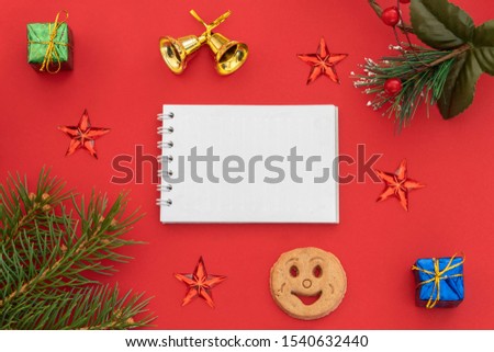 Creative Composition Useful for Christmas and New Year Greeting Card Created Using Gift Boxes, Christmas Bell, Pine Branch, Cookie Smiley, Red Stars and Blank Paper For Text