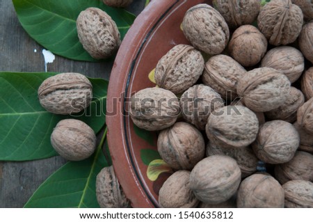 
walnuts and leaves on a wooden table
