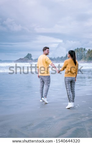 Tofino Vancouver Island , couple on the beach during storm season