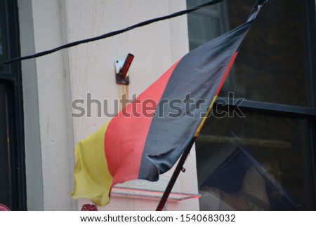 German flag waving on a stormy day