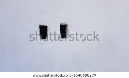 white wall with two holes