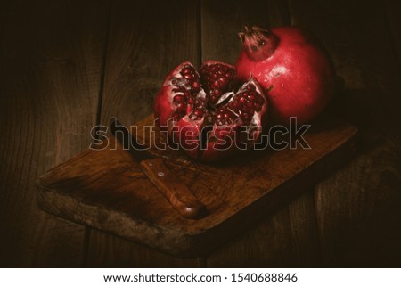 open pomegranate on wooden table