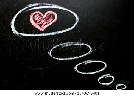 The inscription on the blackboard with chalk. Valentine`s day theme. Dark grunge texture blackboard. Love. I love you. Message of love. The inscription on the blackboard with chalk. Valentine`s day .