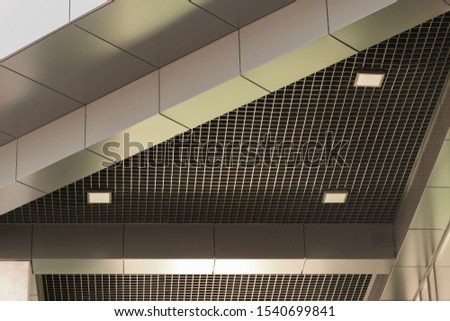 Geometric colored building facade elements with planes, lines and corners with highlights and reflections of light for an abstract background and texture of brown, yellow, gray colors. Place for text