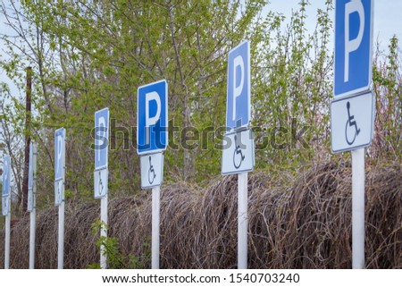 many signs on poles disabled parking