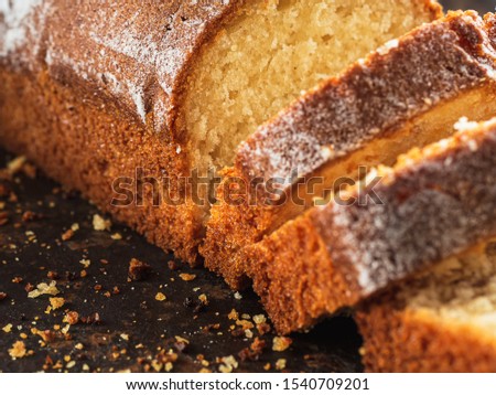 Rectangular loaf cut into pieces with a white sprinkle is on a rusty protvin. Horizontal orientation. close-up.