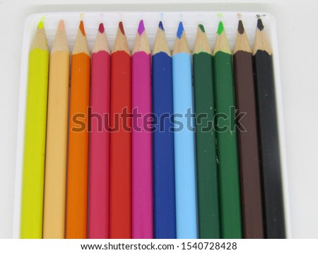 Close up Wooden pencils in all colors seen from the base of the pencils. Colored pencils stacked in rows full Colors art. Back to school kids education. Arranged neat vertical 12 set. Rainbow bright
