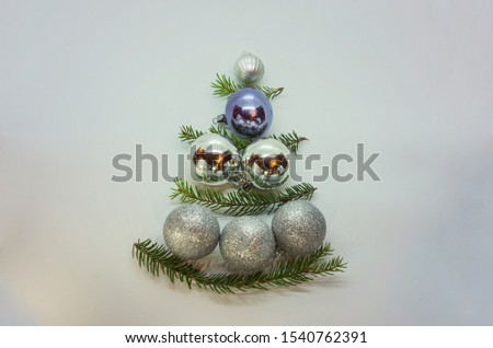 A beautful conceptual Christmas tree made from baubles and decorated by spruce branches. Inversive Xmas tree