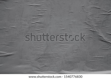 Grey detaching worn stained street poster