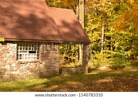 Park stone isolated men's restroom in middle of woods in autumn