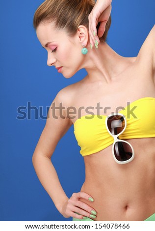 Beautiful casual young woman standing isolated against blue background