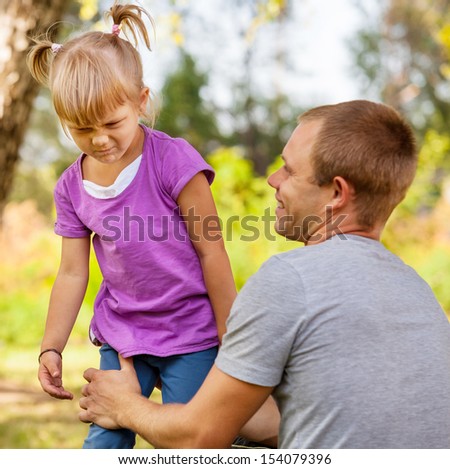 Father talking with cranky little daughter Royalty-Free Stock Photo #154079396
