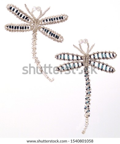 A picture of two beautiful beaded Dragon Flies Christmas tree decorations