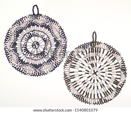 A pic of two round wheels beaded Christmas tree decorations