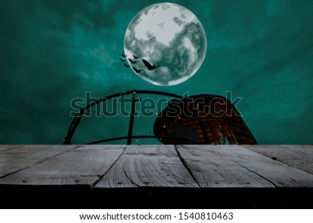 Halloween background. Wooden table. Full moon night.