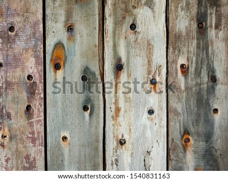 Nails and wood patterns on the wood planks used to make the walls of the room.