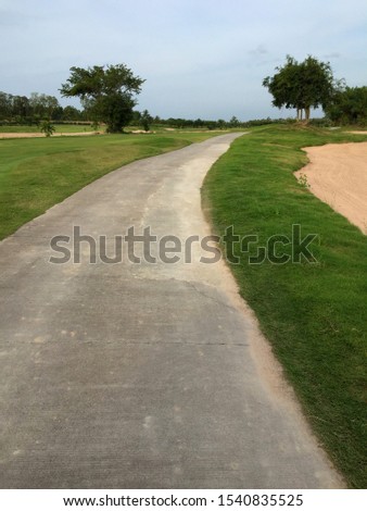 walk way and rough green grass in tropical golf ground