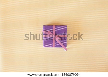 One color gift with ribbons on the pastel background