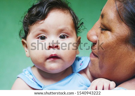 Interracial family. Native american woman with her baby boy. Royalty-Free Stock Photo #1540943222