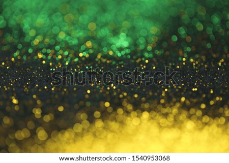 Wallpaper phone shining glitter.New Year and Christmas Festive background. Gold and green glitter  background with shining bokeh on a black background. Shining texture 