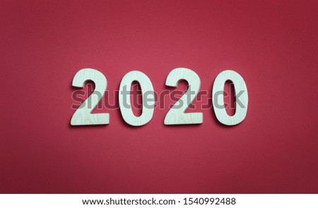 Two thousand and twenty numbers on red art paper background and have copy space for design in your work new year concept.