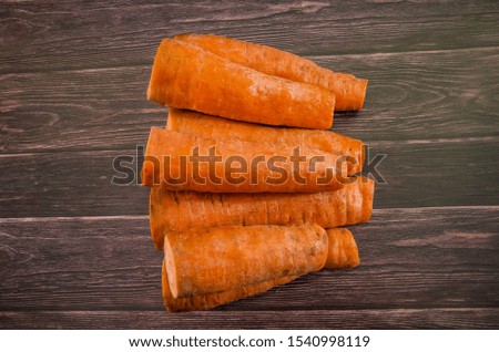 a lot of carrots on a wooden background