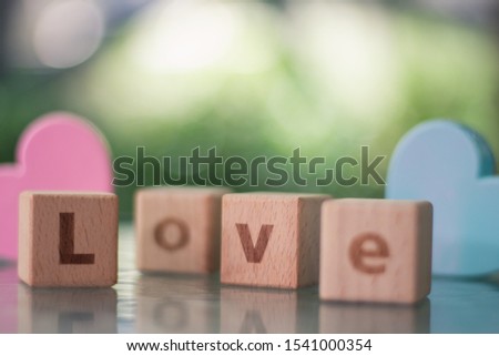 Cube placed on the table Which has to be arranged in order Is a word used to describe feelings to loved ones