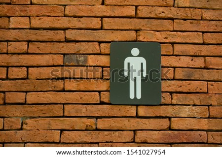Toilet symbol on the wall in garden