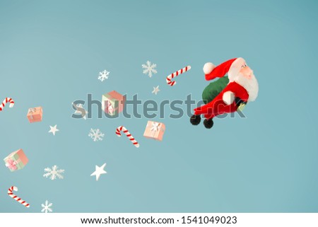 Santa Claus in the sky with Christmas gifts. Delivery New Year presents. Winter holidays minimal concept.