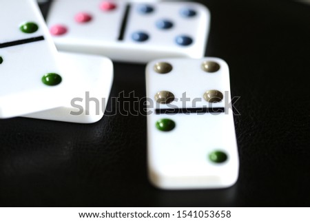 White domino on a black background close-up