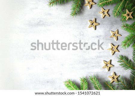 Christmas background with decorations and yellow stars on the gray stone background.