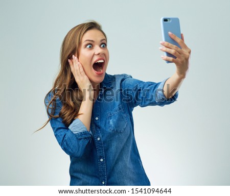 Shocked woman making self portrait with smartphone. 