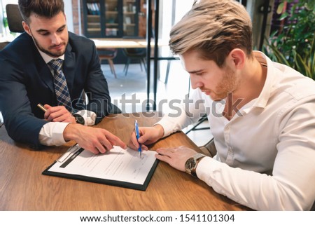 Man signs agreement contract at the office. Business contract, legal agreement concept