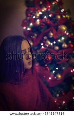Woman at Christmas decorating home.Beautiful Girl near  Christmas tree. 