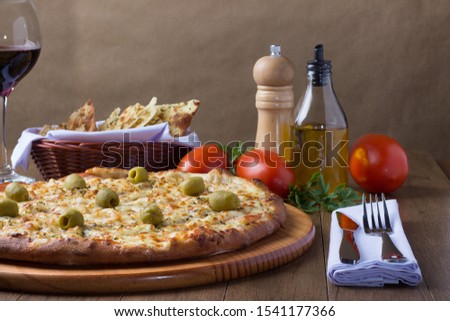 Gratin Loin Pizza. Mozzarella, Canadian Sirloin, Creamy Curd and Green Olives. Accompanied by portion of crostini, ttomates with red wine, red tomatoes, olive oil, black pepper grinder.