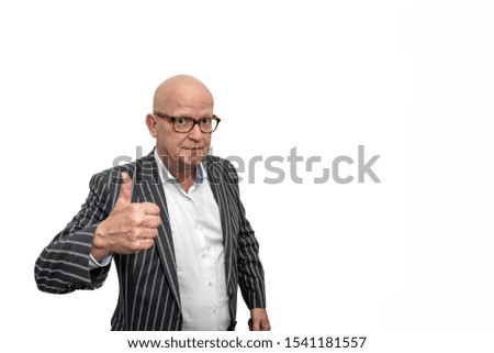 Bald adult man with glasses in a striped jacket makes the gesture thumbs up and is clearly satisfied and pleased