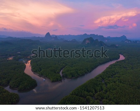 Aerial top view of Samet Nangshe, mountain valley hills, and tropical green forest trees at sunset with Andaman sea in Phang Nga Bay in summer, Thailand in travel trip. Natural landscape background.