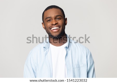 Head shot portrait happy African American man with wide healthy smile, satisfied client customer looking at camera, handsome young male feeling positive, isolated on grey background Royalty-Free Stock Photo #1541223032