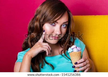 Portrait of young beautiful woman with ice cream on the bright background