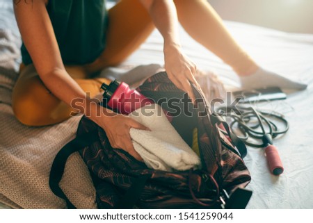 Close up of woman packing sport bag