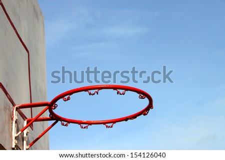 Old basketball hoop and board on blue sky background