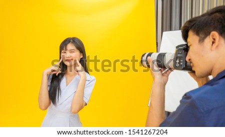 Happy women model with photography Portrait of a photographer and women model, Behind the shooting production crew team camera and equipment indoor studio, photography working behind concept