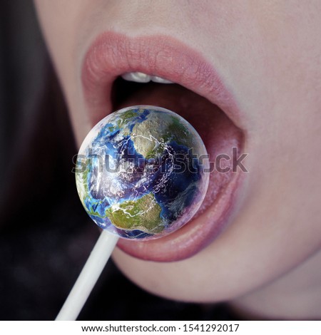 Female mouth with lollipop looks candy like a planet Earth. Digital art image, including elements furnished by NASA.