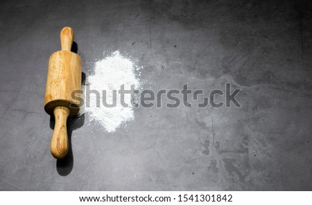 dough roller wood and Pastry Flour on background
